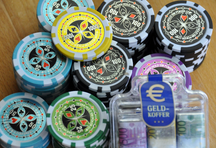 A collection of poker chips and a money suitcase with euro notes
